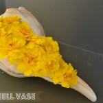 Simple Flower arrangement, marigolds, seashell vase