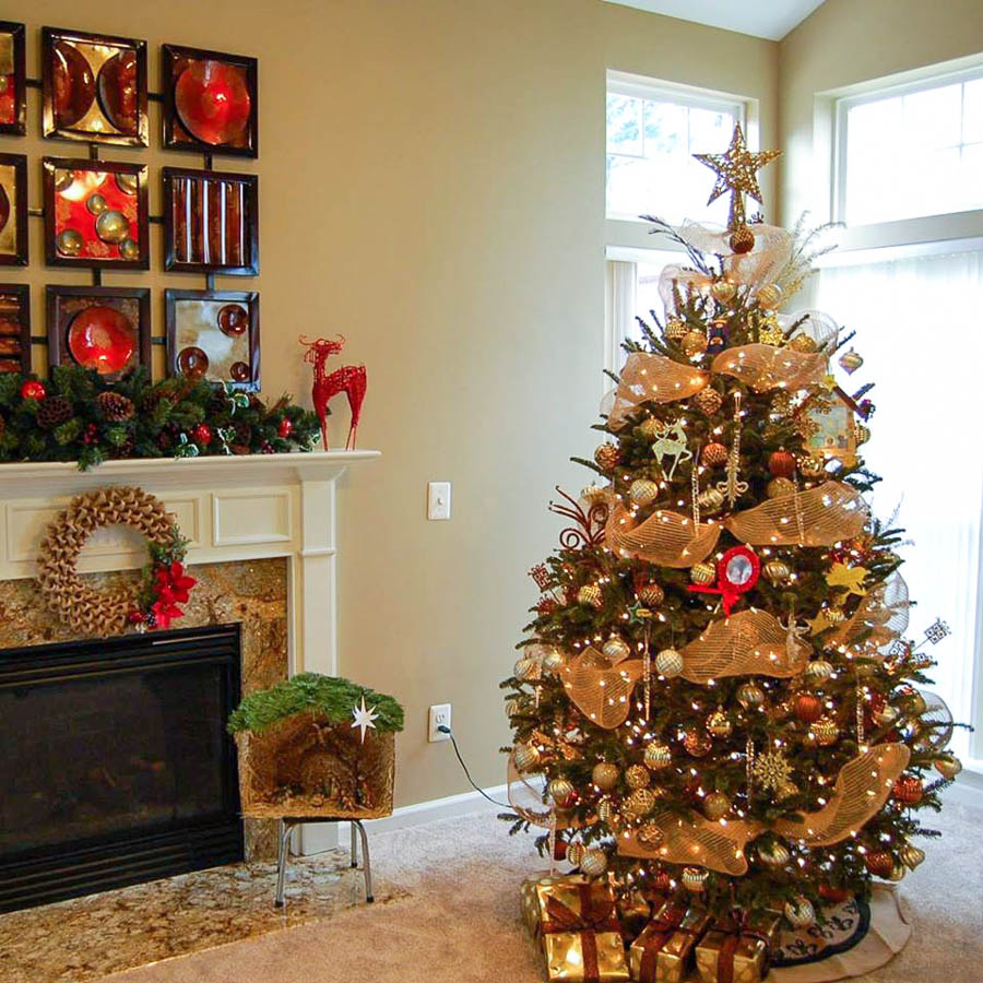 Gold themed Christmas tree and holiday mantel