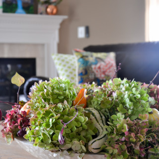 Fall centerpiece with pumpkins gourds and hydrangeas