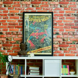Accent brick wall with in family room- spiderman poster, loft style family room